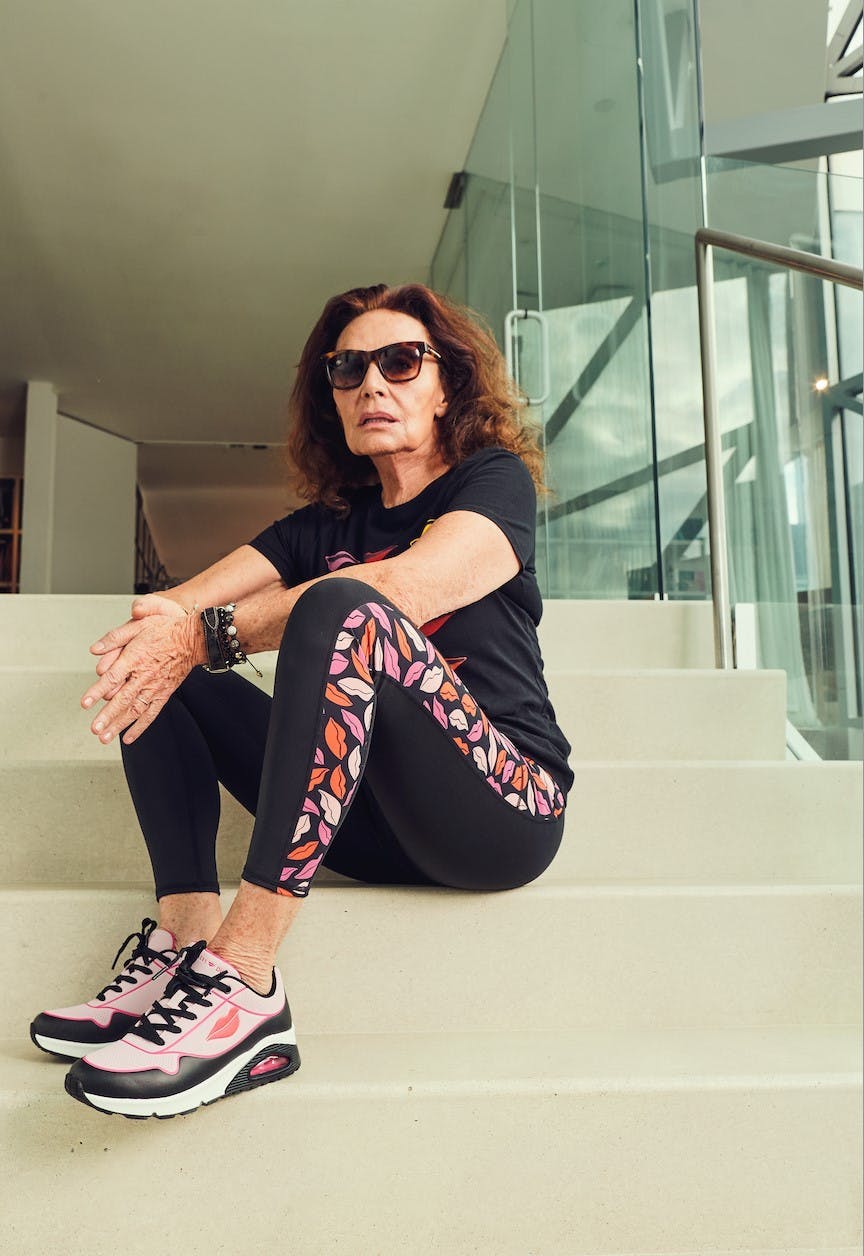 person sitting footwear shoe adult female woman accessories sunglasses sneaker