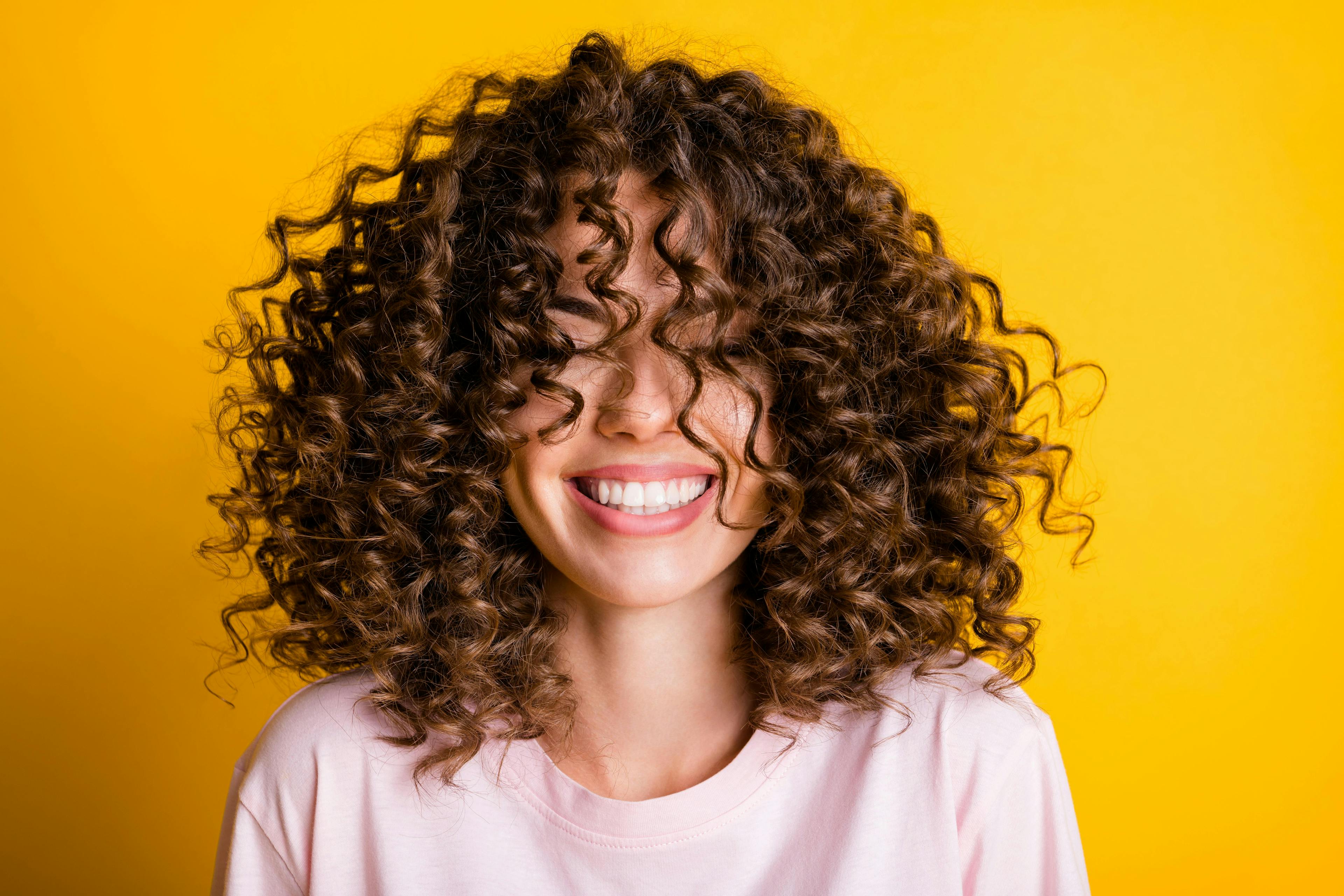 happy,conditioner,good,smile,beautiful,trendy,casual,model,female,laugh,cheerful,haircare,haircut,girl,hairstyle,volume,whitening,careless,veneers,rejoice,style,laughter,salon,overjoyed,treatment,pink,woman,mood,dentistry,student,young,bright,yellow,summer,hair,joy,brunette,leisure,expression,curly,carefree,curls,lifestyle,stylish,face,emotion,toothy,fun,fashion,t-shirt