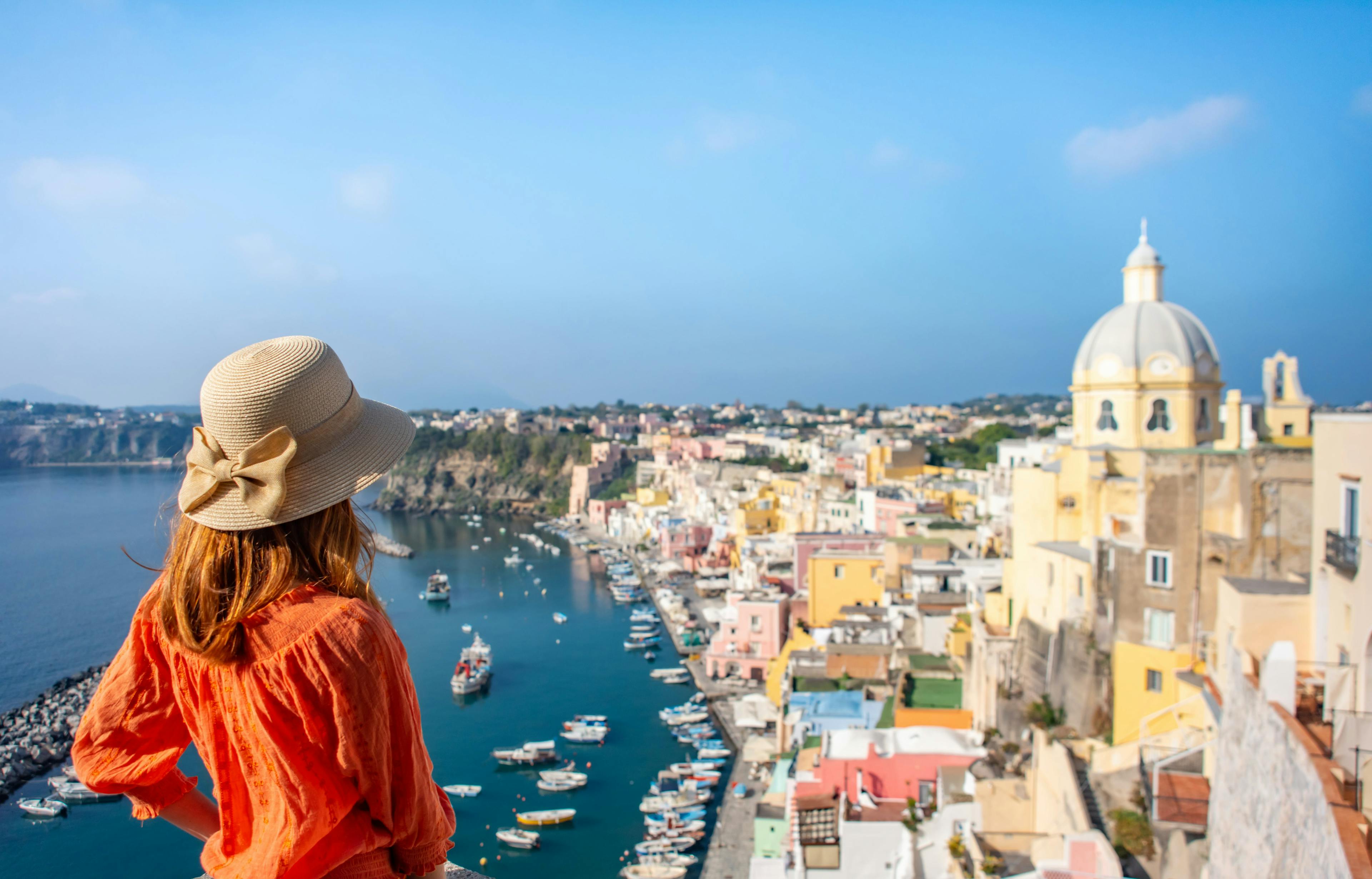 woman,young,church,happy,destination,panoramic,tourism,corricella,scenic,sea,space,summer,tourist,beautiful,rear,seascape,view,hat,copy,female,landmark,europe,naples,procida,italy,architecture,town,nature,island,relax,italian,girl,mediterranean,coast,marina,buildings,sensuality,travel,landscape clothing hat sun hat adult female person woman boat vehicle cityscape