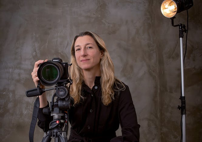 photography tripod adult female person woman face camera electronics portrait