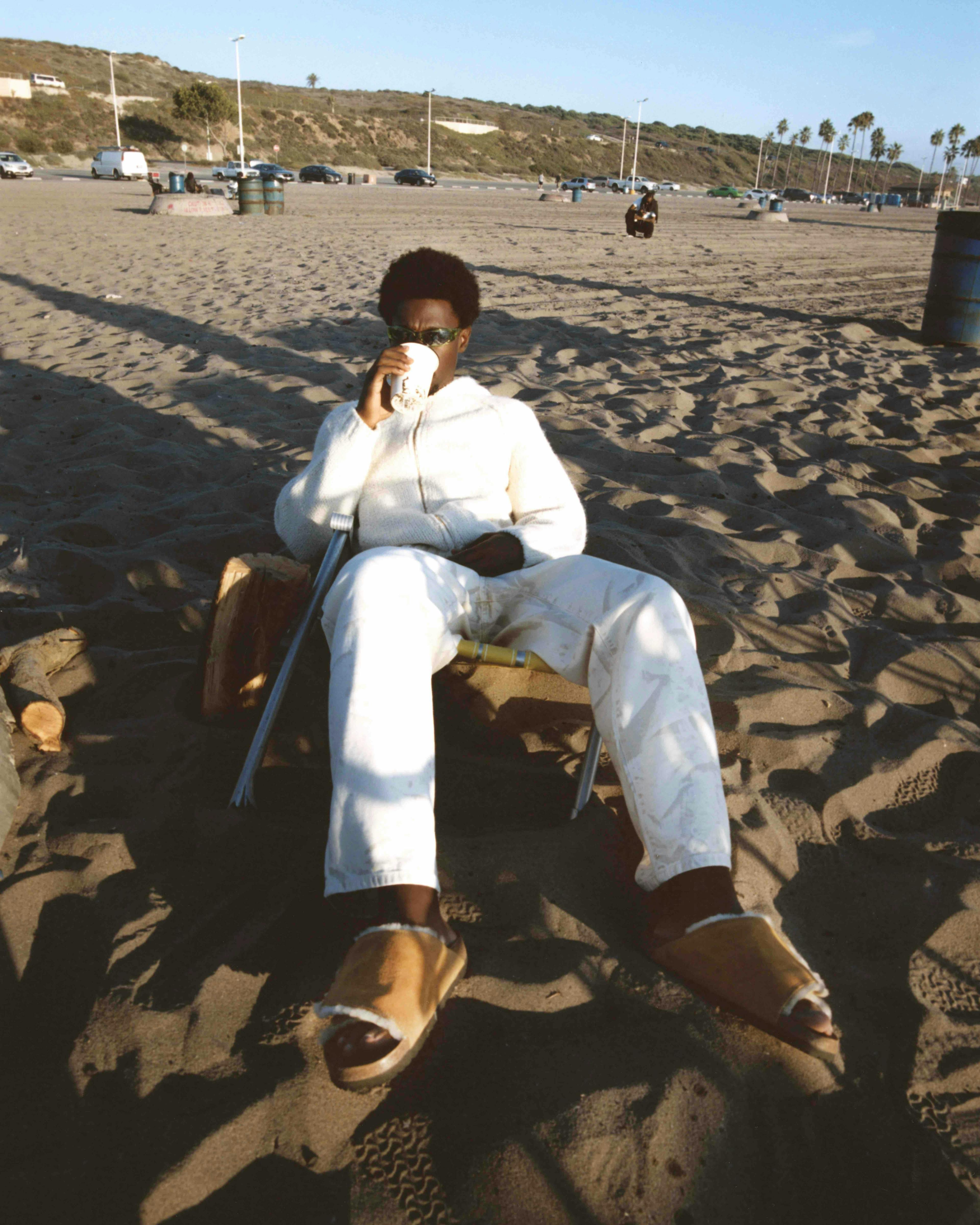 photography person sitting portrait pants beach outdoors sea beachwear shoe